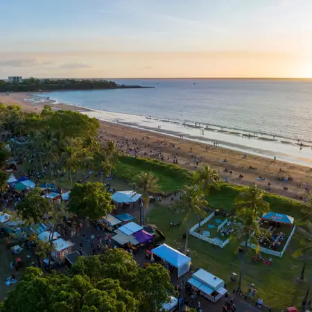 An aerial shot of markets on a beachfront