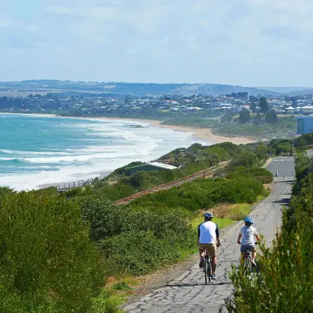 A couple riding along a coastal pathway in Victor Harbor.