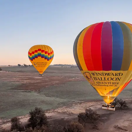 Two colourful hot air balloons in the air